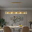 Marini 59-inch linear crystal chandelier over a long dining table