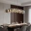 Giatti modern glass dining chandelier in gold over a table