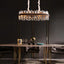 Calvi smoke and clear crystal dining chandelier over a table
