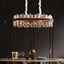 Calvi crystal dining chandelier on polished steel over a table