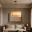 Valmont 24-inch round marble chandelier glowing warm from within