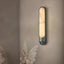 Sandford marble and stainless steel wall sconce in a hallway