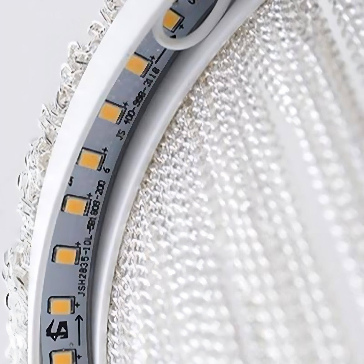 Detail of the Cadena pendant's fine aluminum chain tassels catching warm light, from Morsale.com.