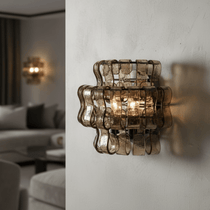 Riviera smoke glass sconce with warm glowing shade