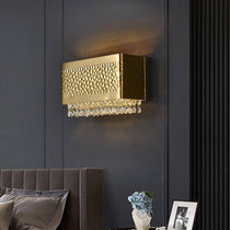 The Bern gold crystal sconce from Morsale.com mounted on a wall, two warm G9 LED sources glowing through K9 crystal.