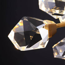 The Diamante chandelier by Morsale.com illuminated over a bar, fifteen G9 LED crystal orbs on warm copper.