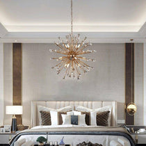 The Weston Sputnik crystal chandelier from Morsale.com above a dining table, rose gold arms radiating with crystal sparkle.