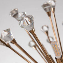 The Weston Sputnik chandelier by Morsale.com lit in a foyer, K9 crystal scattering warm light from rose gold arms.