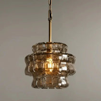 Riviera smoke glass pendant illuminated over a kitchen island