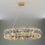 Monte crystal wheel chandelier by Morsale.com, a 31-inch wheel of smoke grey and clear K9 crystal on a polished steel frame above a dining table.