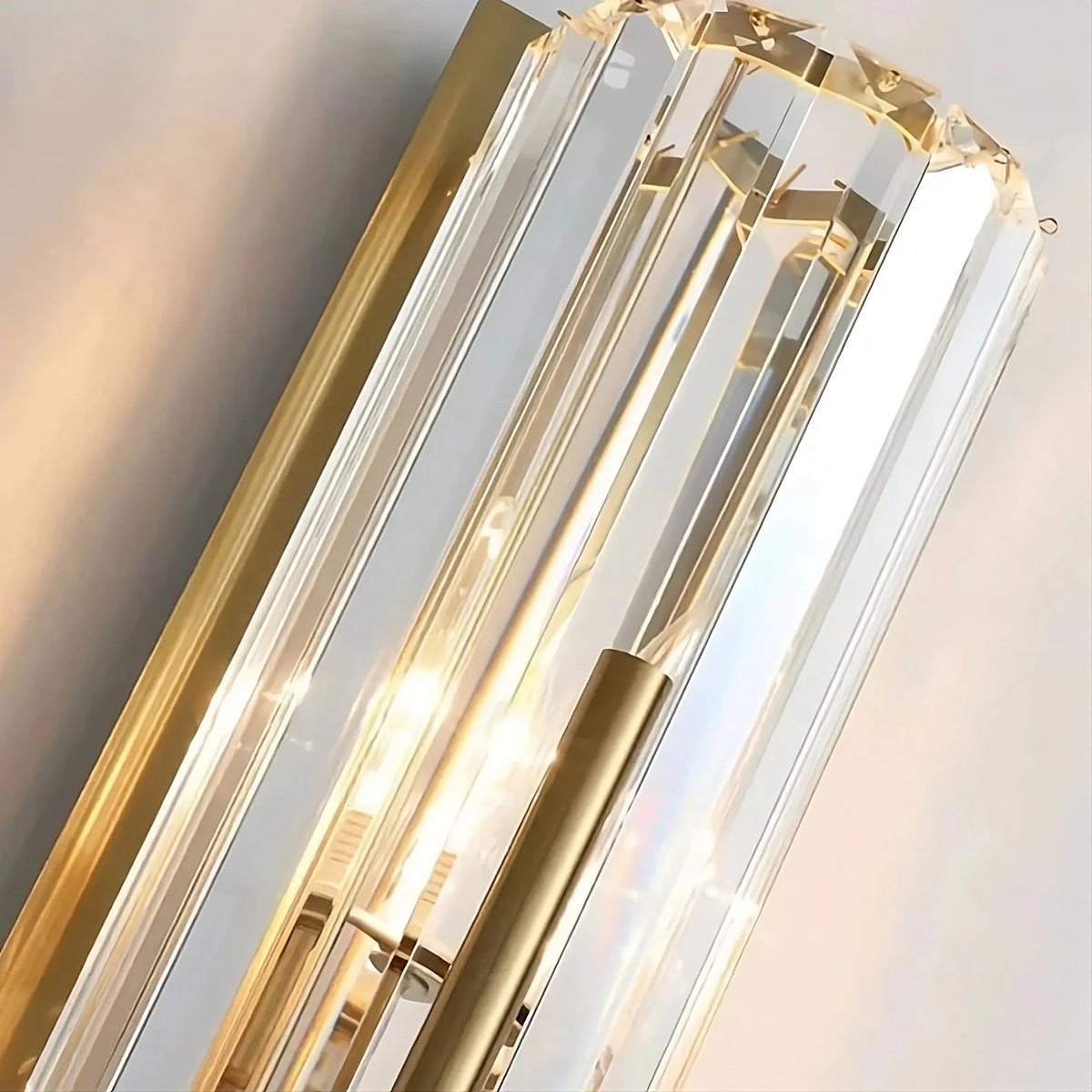 Pair of Gio brass crystal wall sconces in a hallway