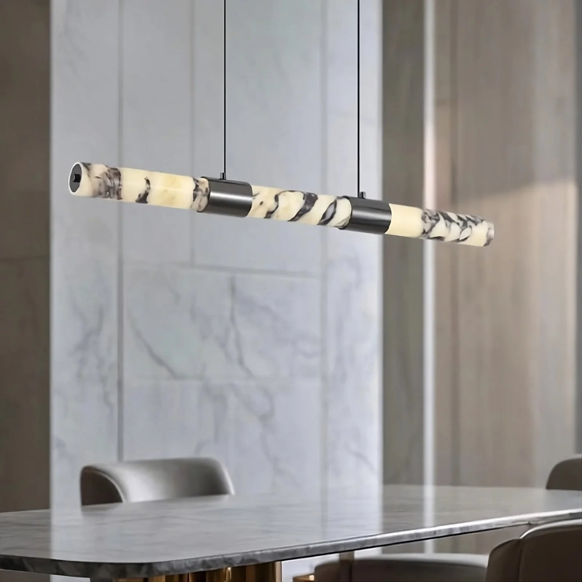 Warner marble linear suspension light illuminated over a table