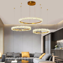 The Capri 3-ring chandelier from Morsale.com casting a refined glow, tiered crystal rings with concealed LED strips.