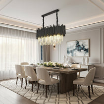 The Vigo crystal dining chandelier from Morsale.com casting dramatic sparkle over a table, crystal on polished steel.