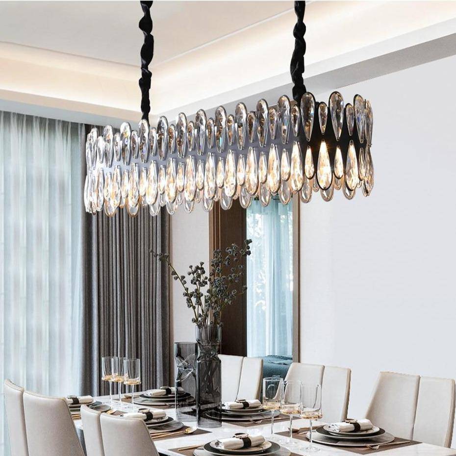 The Napoli crystal dining chandelier from Morsale.com casting a warm glow over a table, K9 crystal on polished steel.