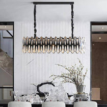 Napoli modern dining room chandelier by Morsale.com, a 36-inch linear fixture of K9 crystal on ornate stainless steel arms above a dining table.