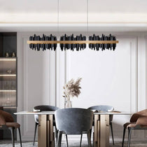 Detail of the Rivaro linear chandelier's black and gold frame