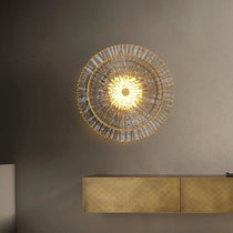 Clara brass and glass wall sconce illuminated, warm glow