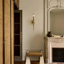 Valen wall sconce with glowing marble shade on forged brass