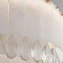 Stuart marble and crystal round chandelier over a dining table