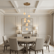 Auris 9-light marble chandelier illuminated over a dining table