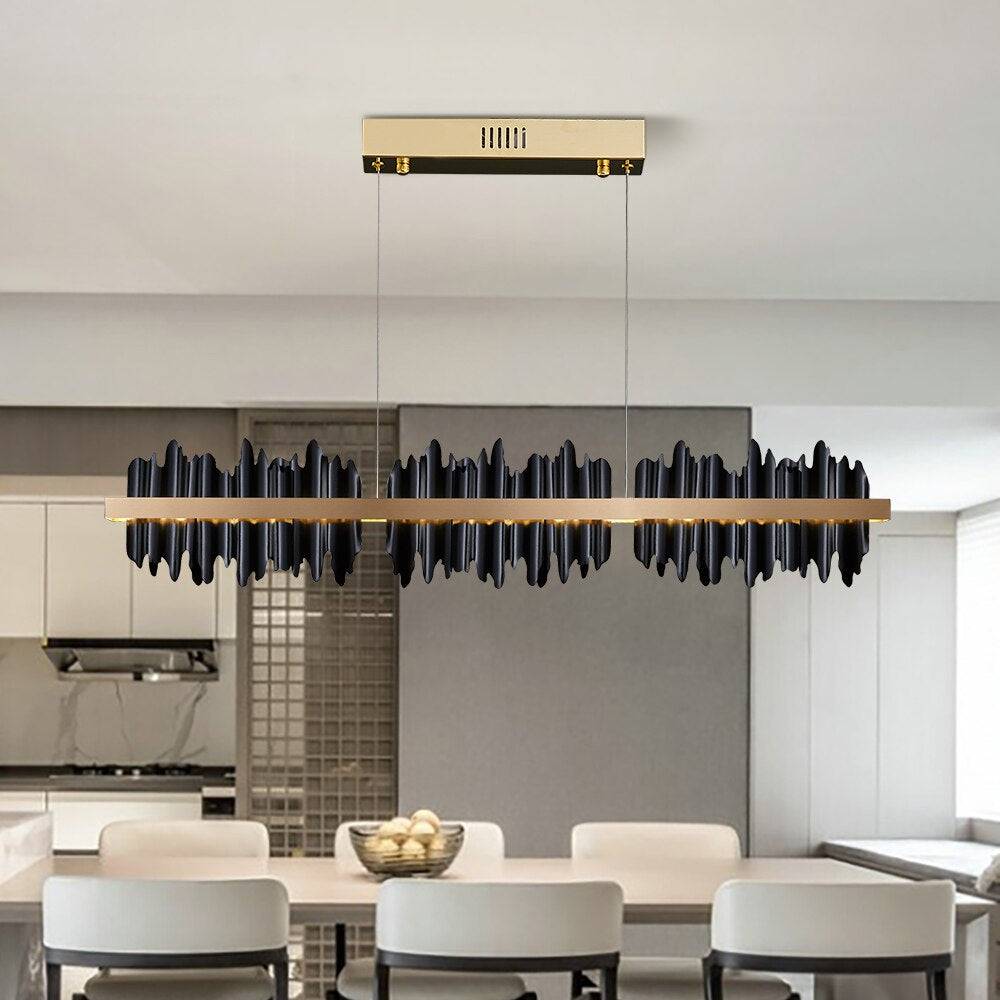 Rivaro modern linear chandelier in black and gold over a dining table