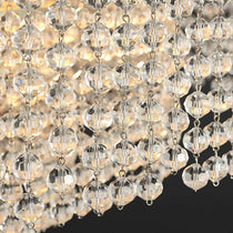 Alleri crystal dining chandelier illuminated above a kitchen island