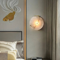Auralis marble wall sconce mounted on a wall