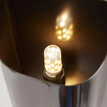 Rame copper wall sconce full view against a neutral wall