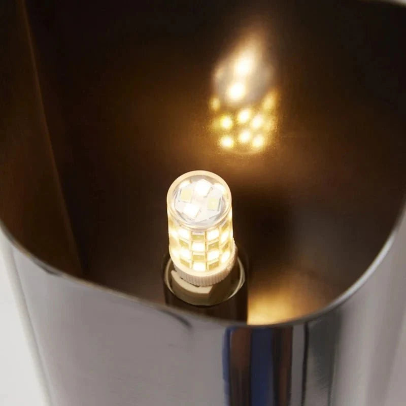 Rame copper wall sconce full view against a neutral wall