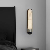 Sandford sconce casting up and down light on a wall