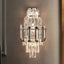 Lazzo smoke and clear crystal wall sconce in a hallway