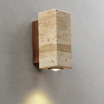 Natural travertine and walnut wall light in a hallway