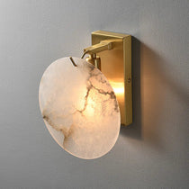 Auralis marble sconce with glowing natural stone shade