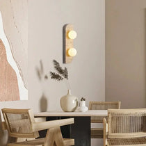 Sonte travertine sconce with warm glowing stone shade