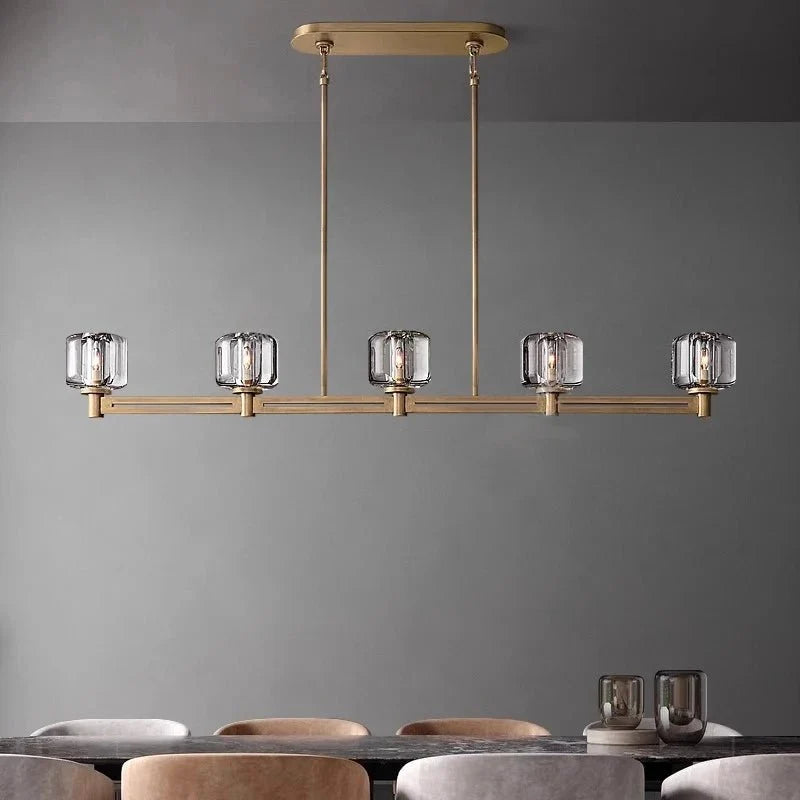 Ventoux linear crystal and brass chandelier over a dining table
