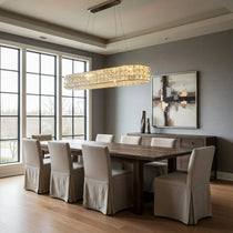 Bacci gold crystal chandelier illuminated over a dining table