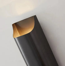 Rame copper wall sconce mounted on a bedroom wall