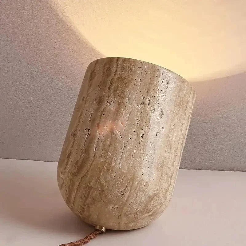Modern travertine table lamp on a nightstand