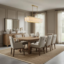 Stanton brass and marble dining chandelier illuminated over a table