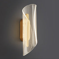 Lamina LED wall sconce casting a warm glow in a hallway