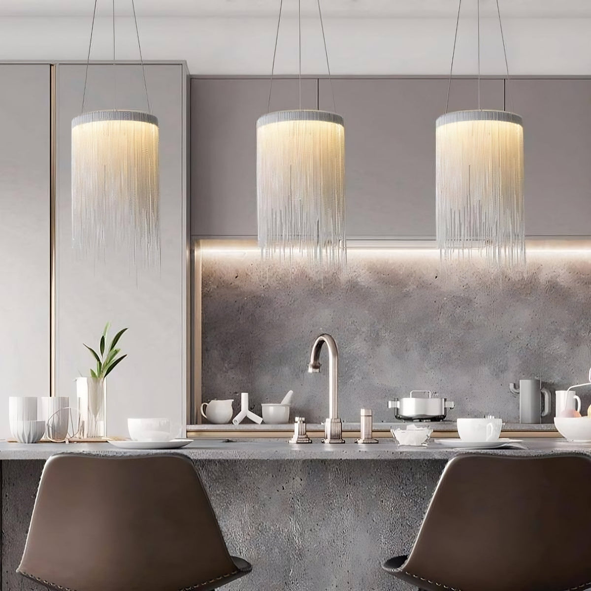Cadena chain tassel pendant light by Morsale.com, fine aluminum chain tassels on a stainless steel canopy with warm LED glow.