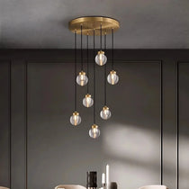 Bossen 7-globe chandelier illuminated over a dining table