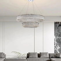 Bacci 39-inch modern crystal chandelier illuminated over a table