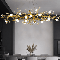 Albero sculptural gold branch chandelier illuminated