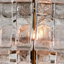 Riviera modern chandelier casting a warm glow in a living room