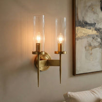 Palermo brass wall sconce illuminated with a warm glow