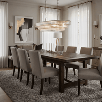 Riviera clear glass chandelier refracting bright light over a table