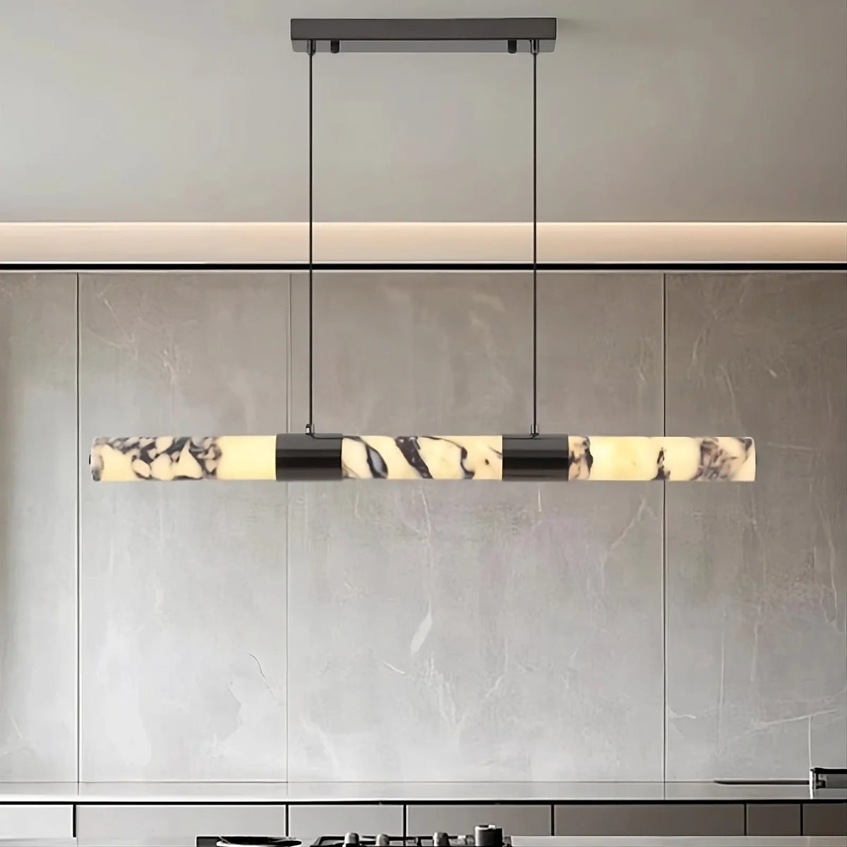 Warner linear marble suspension light in brass over a table Main image
