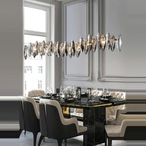 Lazzo crystal dining chandelier illuminated above a long table